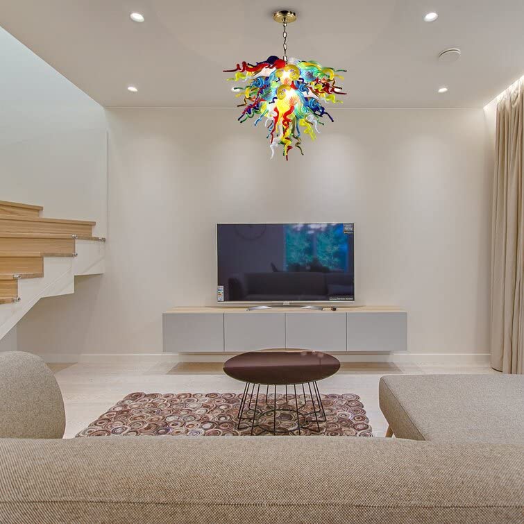 Vibrant multi-color hand blown glass chandelier enhancing a modern living room with a large TV and minimalist decor.
