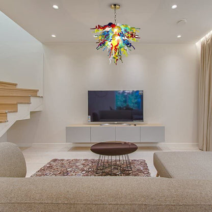 Vibrant multi-color hand blown glass chandelier enhancing a modern living room with a large TV and minimalist decor.