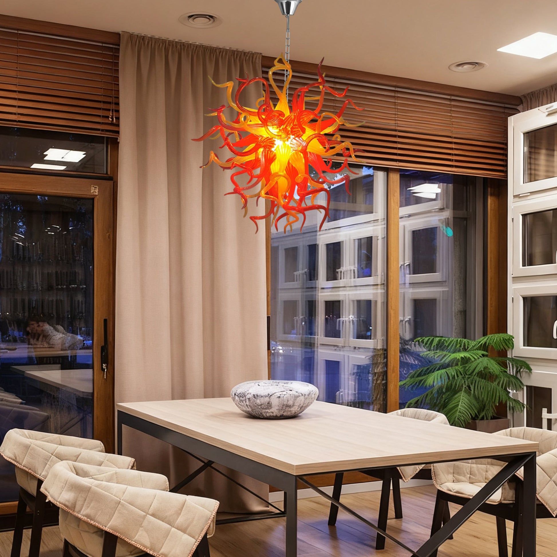 Chihuly-style red-orange hand blown glass chandelier in contemporary dining room.