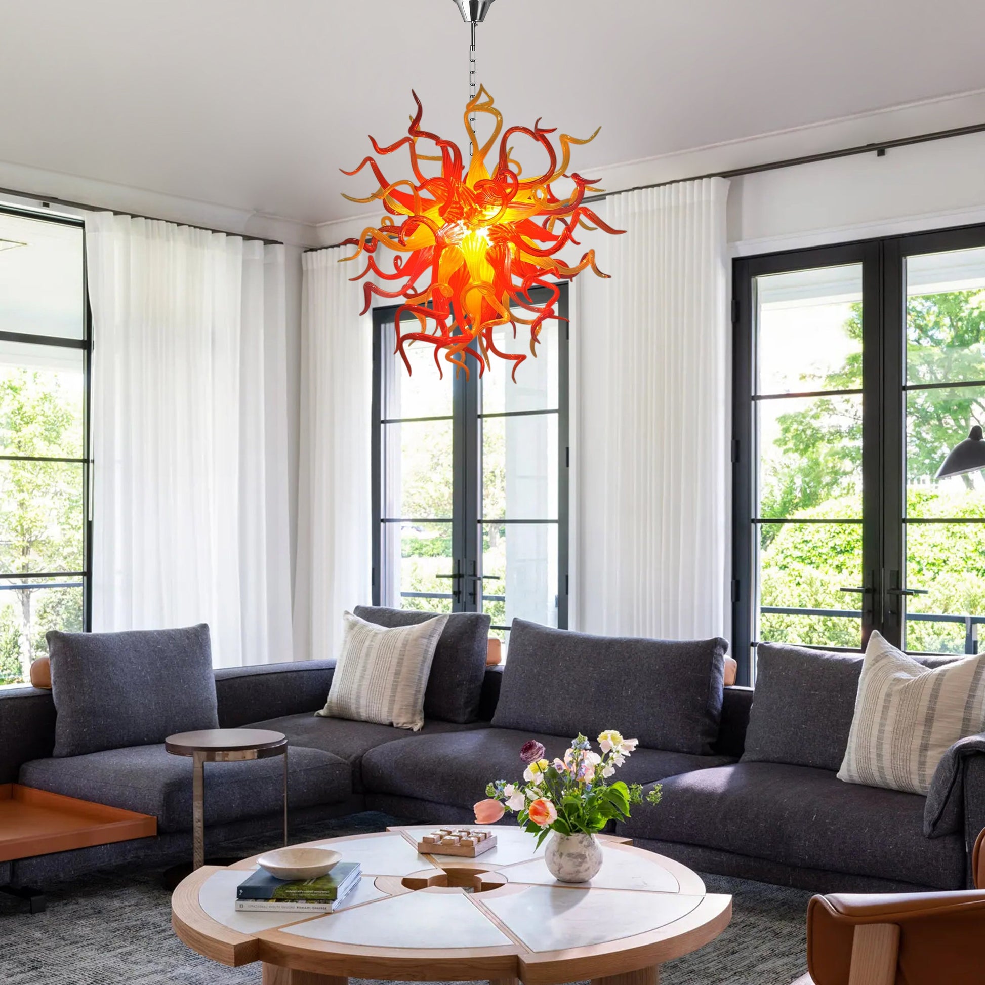 Red and orange Chihuly inspired hand blown art glass chandelier in a traditional living room.