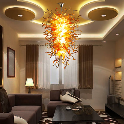 Modern living room featuring a vibrant amber hand blown glass chandelier as a unique, artistic light source above the seating area.