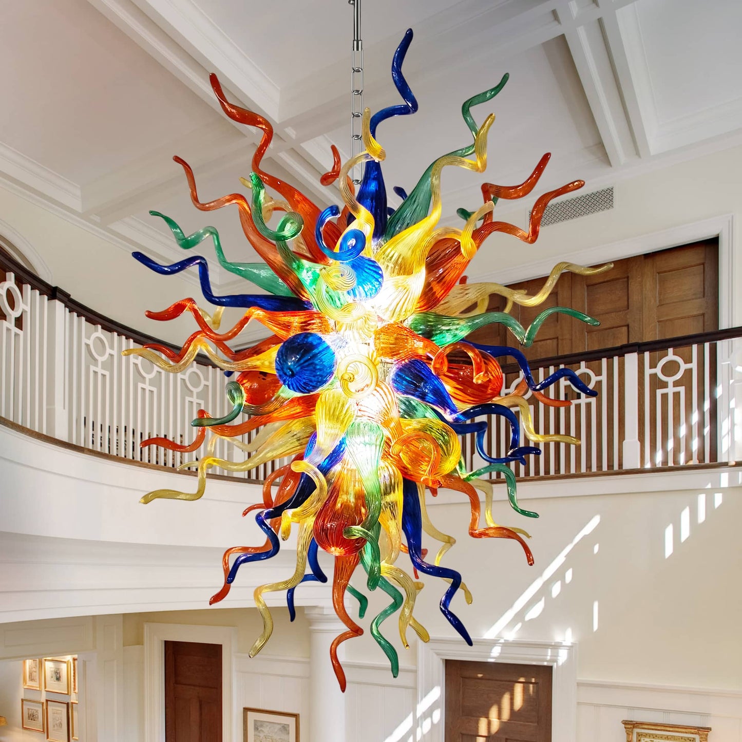 Colorful hand blown glass chandelier as a grand centerpiece in a spacious foyer.