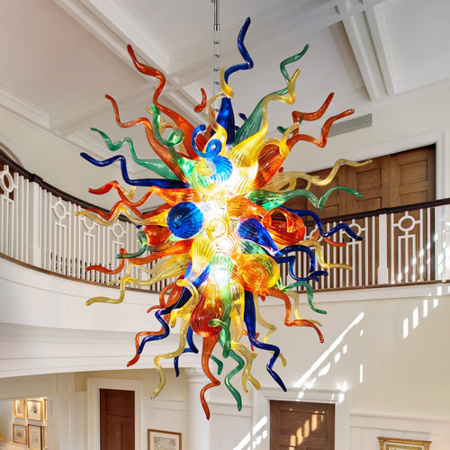 Colorful hand blown glass chandelier as a grand centerpiece in a spacious foyer.