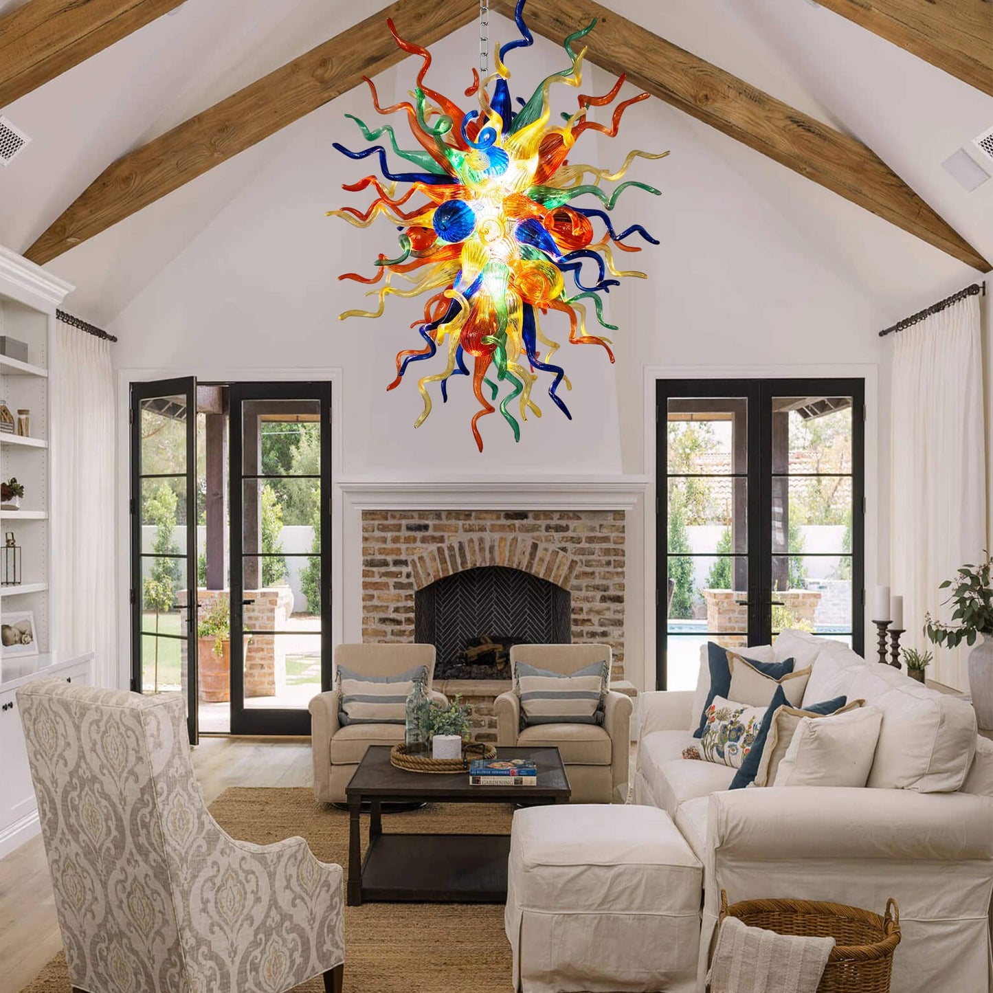A modern living room interior designed with a vibrant multi-color blown art glass chandelier as the stunning centerpiece.