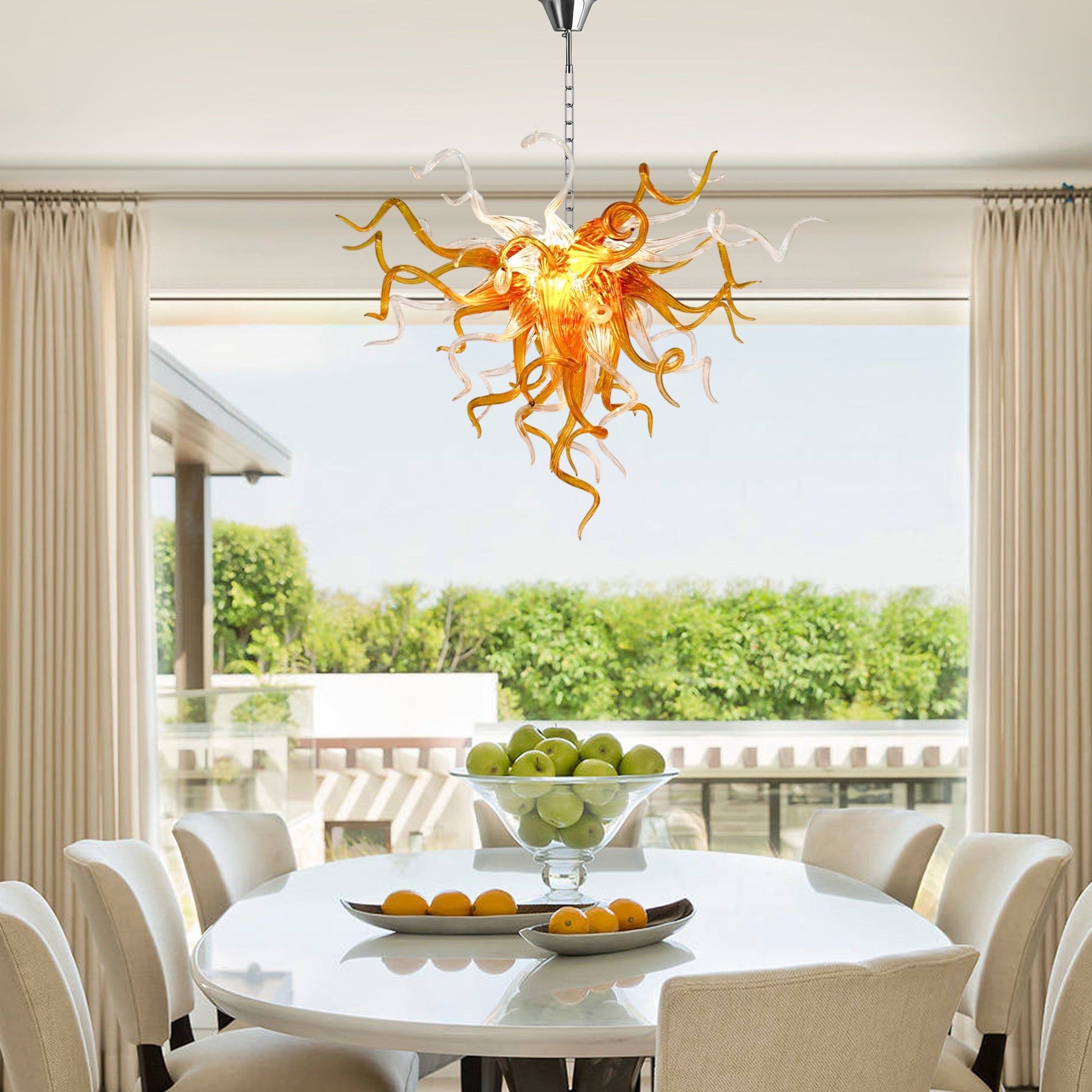 Amber and clear Chihuly-style hand blown glass chandelier in elegant dining room.
