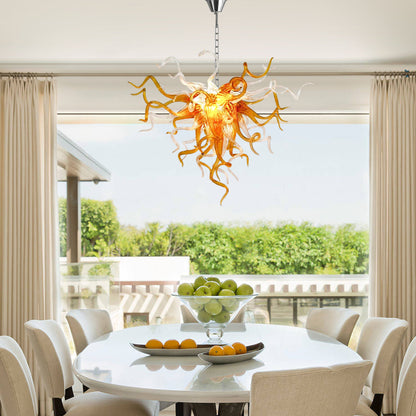 Amber and clear Chihuly-style hand blown glass chandelier in elegant dining room.