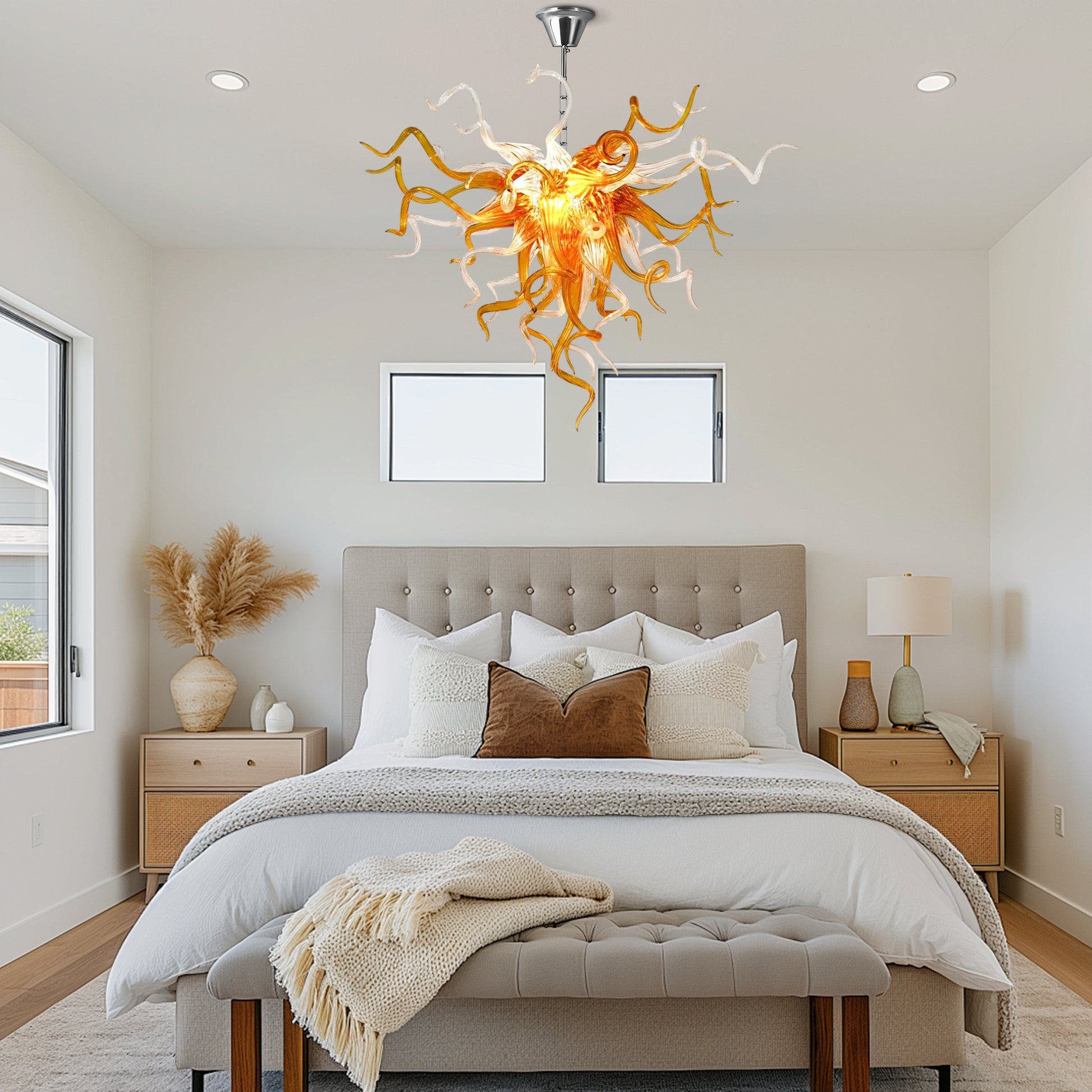 A Chihuly-style amber hand blown glass chandelier in a rustic bedroom.