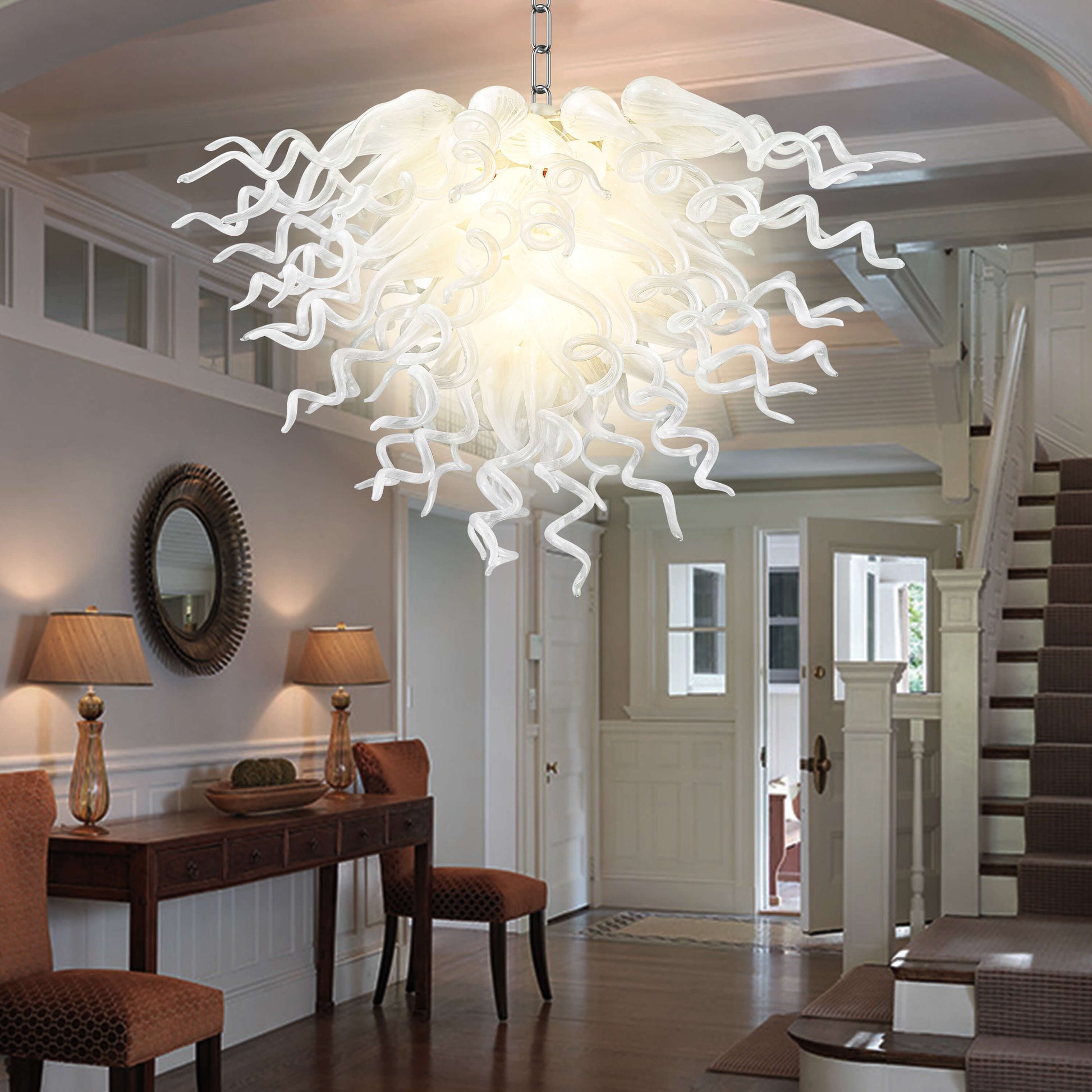 Modern living room decor highlighted by the radiant glow of a Chihuly-style pearl white blown glass chandelier.