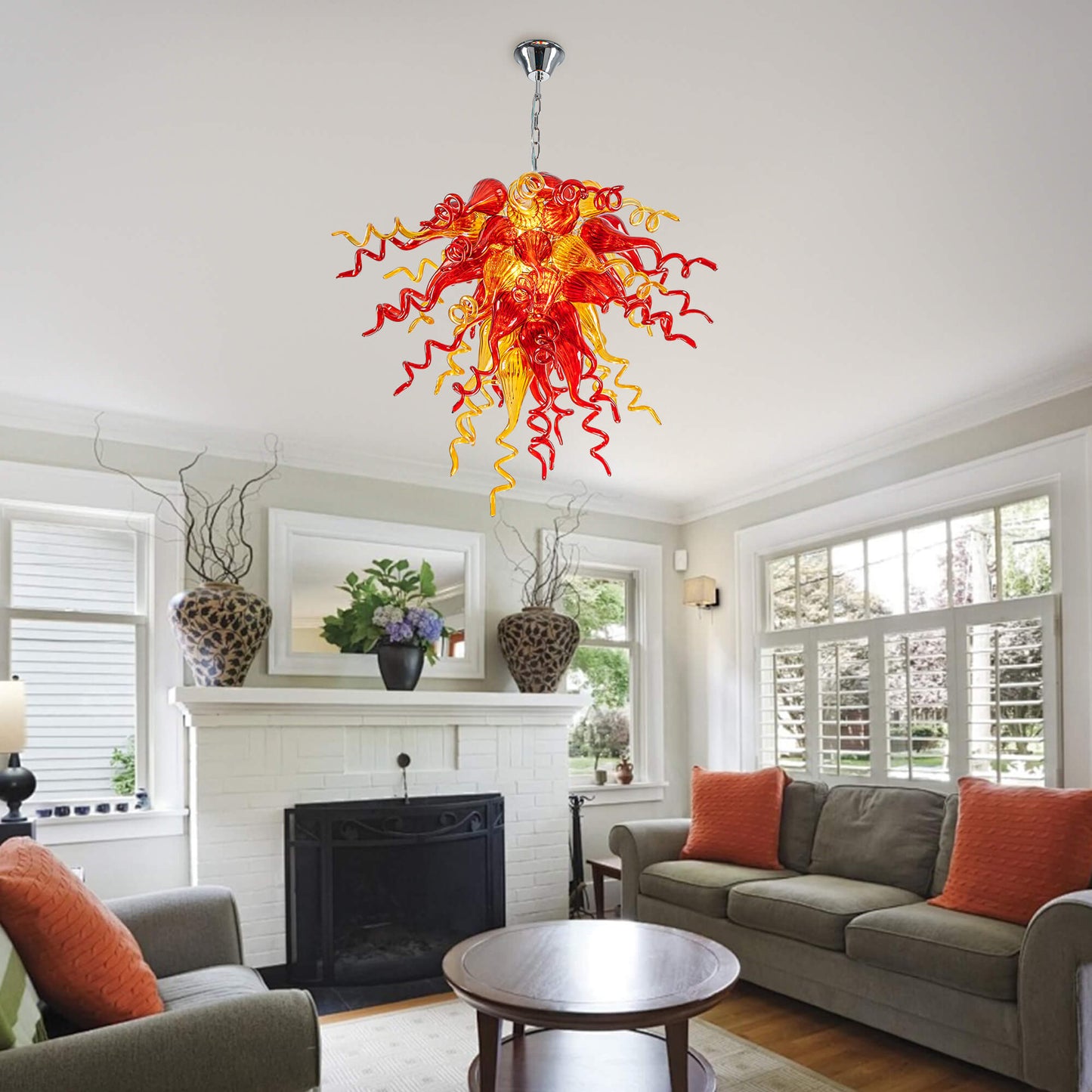 Vibrant Red Hand Blown Glass Chandelier in a modern living room with a white textured stone fireplace.