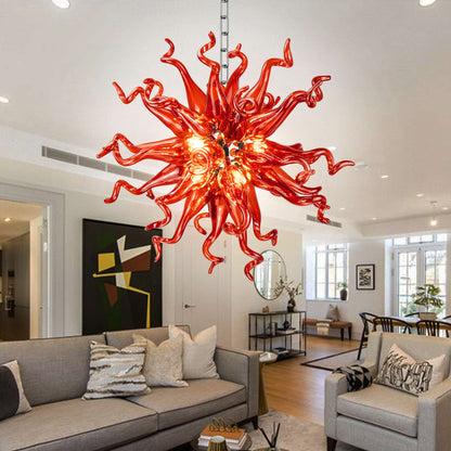 Elegant living space featuring a stunning red hand-blown glass chandelier over the living room counter.