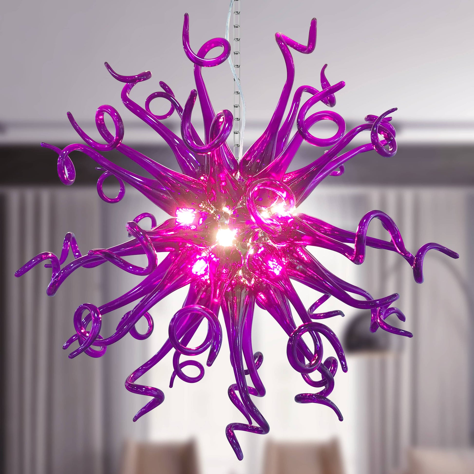 Detail of the luxurious purple tones and flowing lines of a hand blown art glass chandelier.