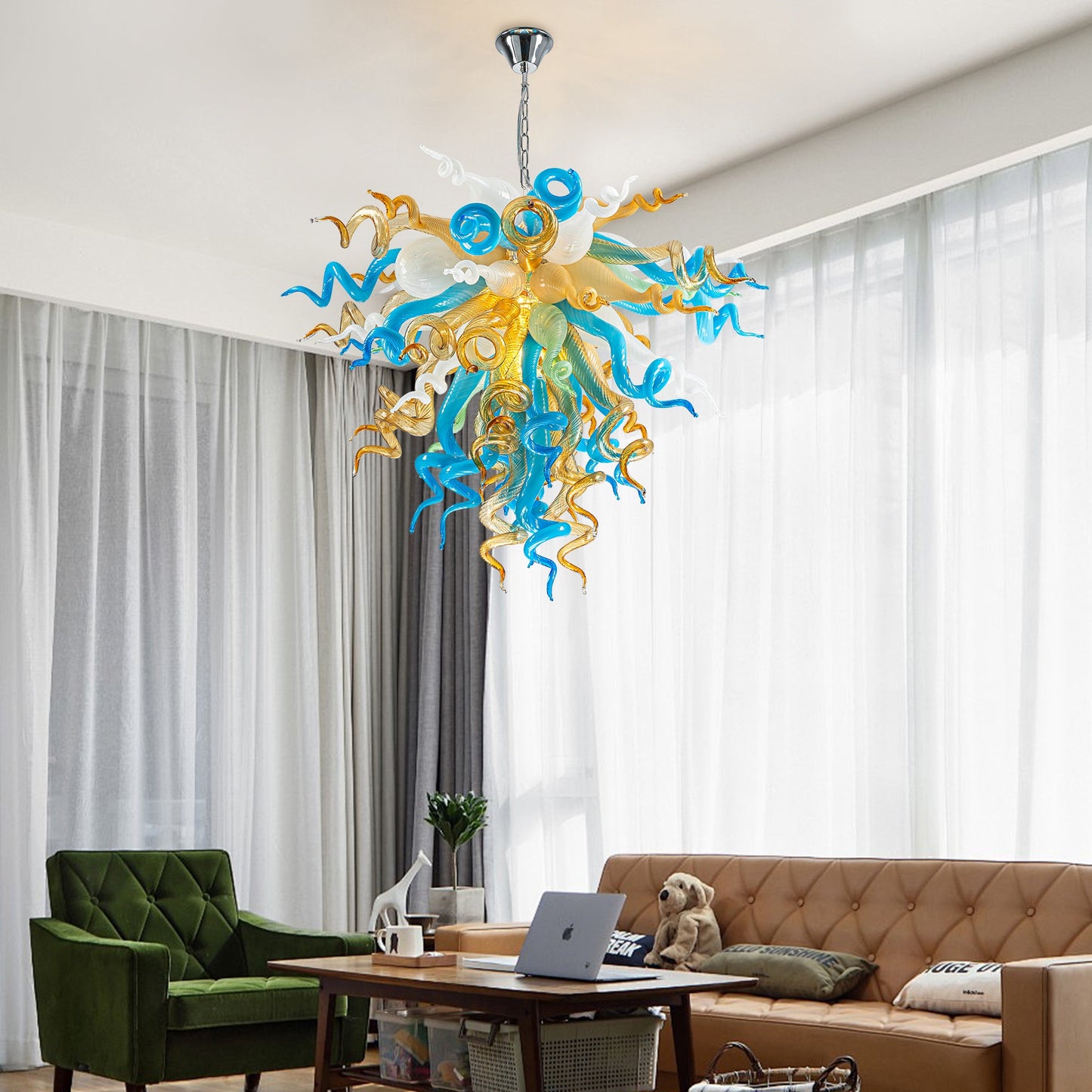 Coastal elegance hand blown glass chandelier in blue, gold, and white, hanging over living room.