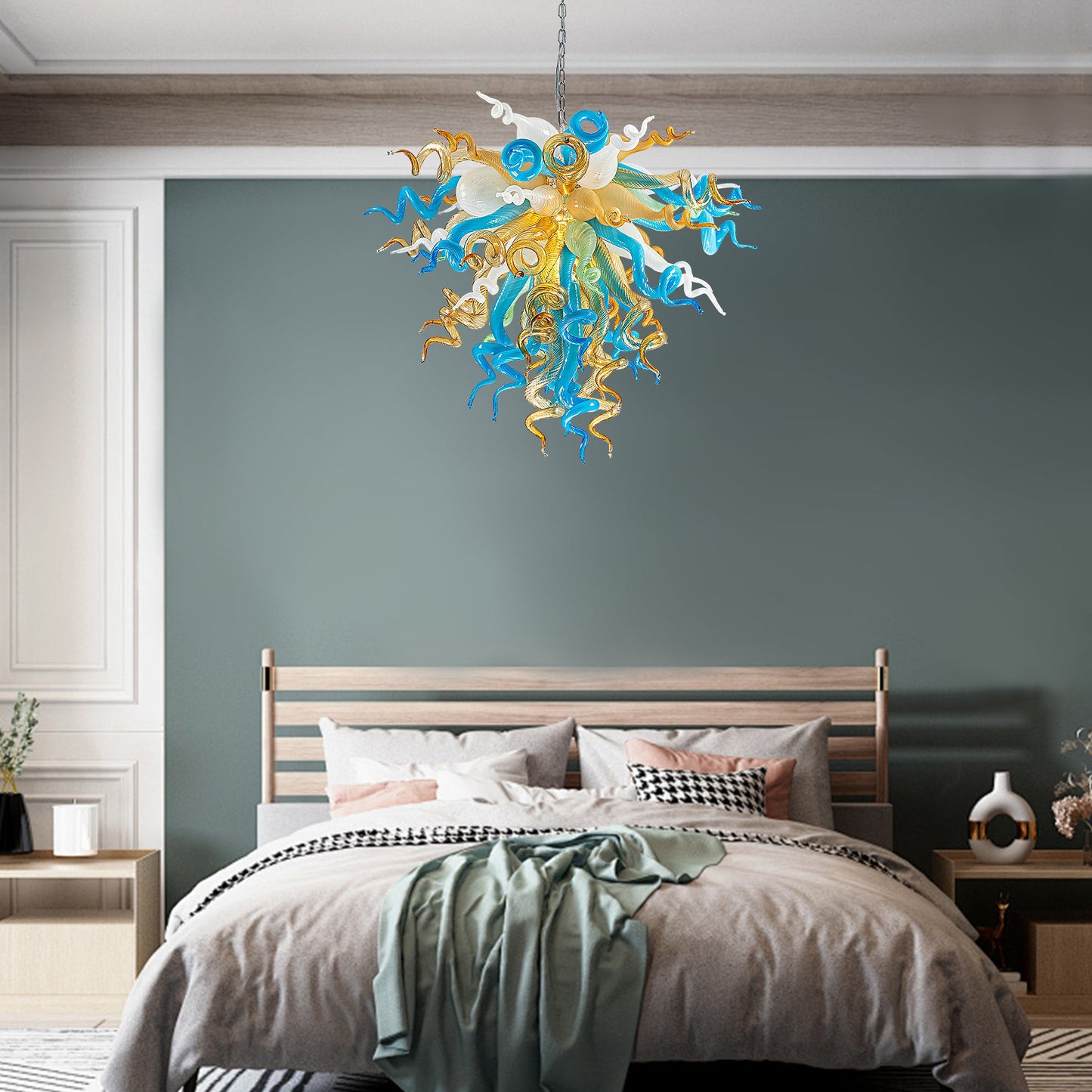 Modern blue and gold hand blown glass chandelier creating a sophisticated ambiance in bedroom.