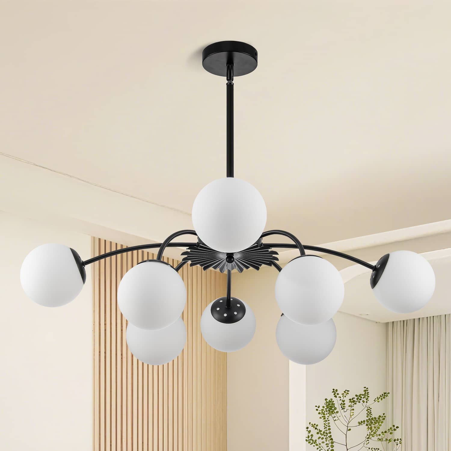 Unlit black 8-light frosted glass pendant globe chandelier in modern styled room.