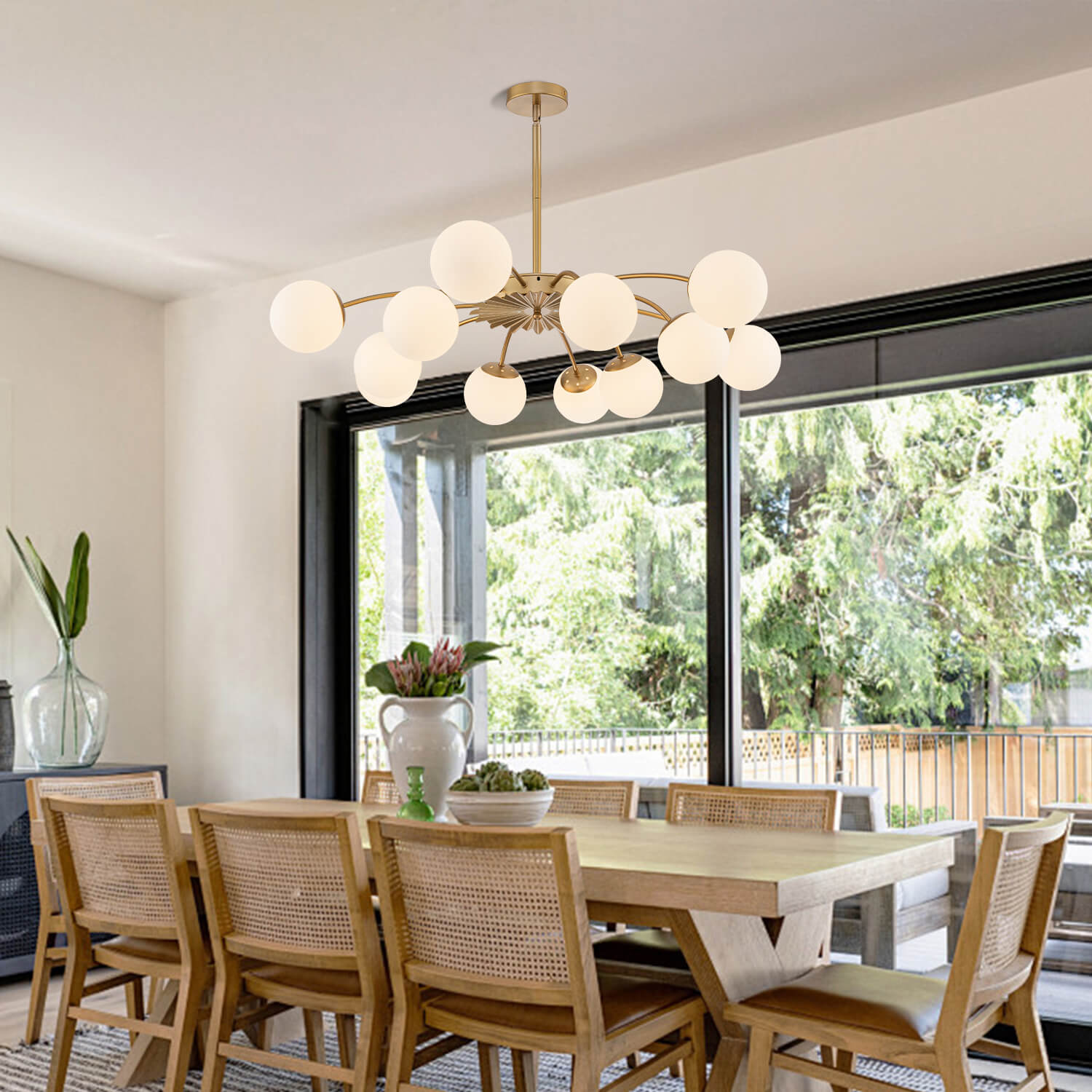 12-Light frosted glass pendant hanging globe chandelier over a large wooden dining table.