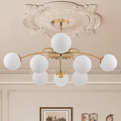 Unlit gold 8-light frosted glass bubble globe chandelier in traditional room.