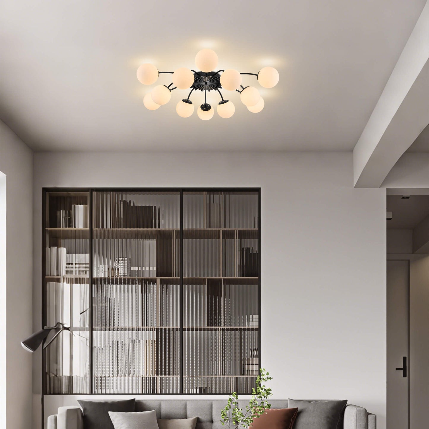 Modern 12-light black frosted glass bubble ceiling light in airy living room.