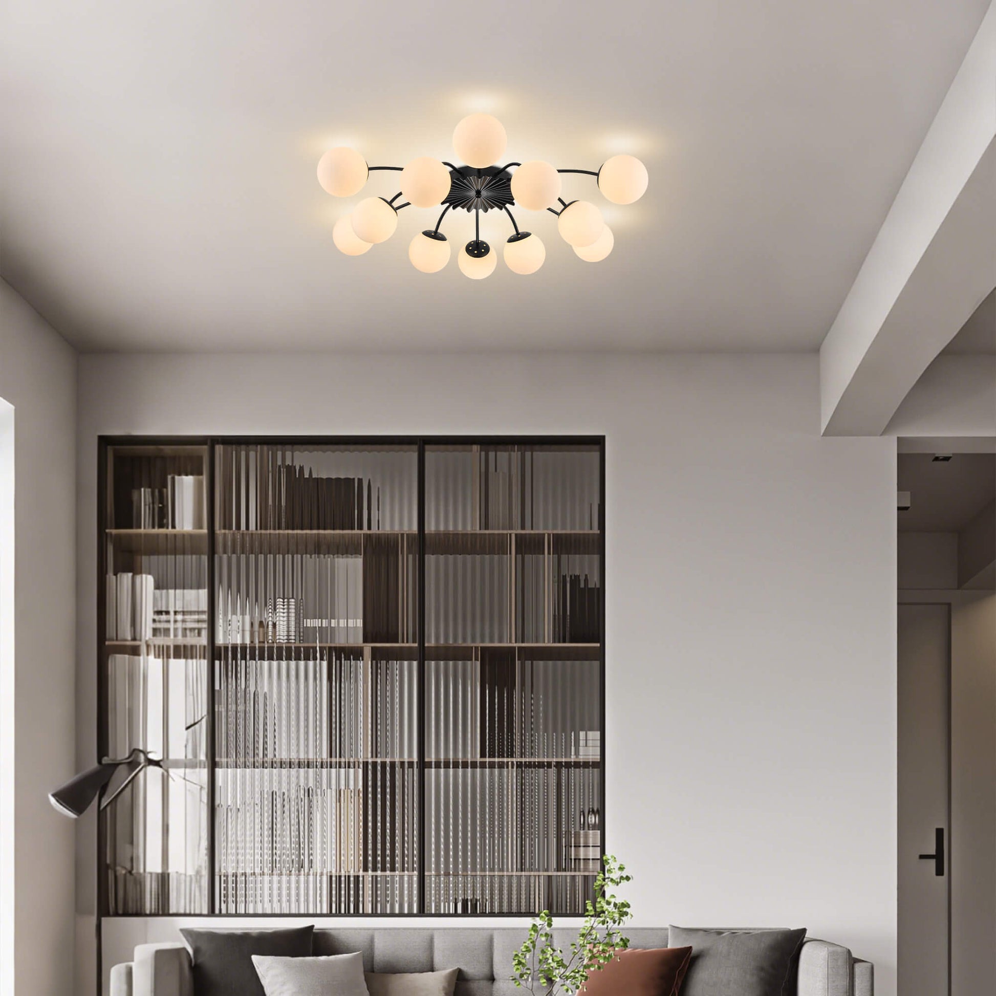 Modern 12-light black frosted glass bubble ceiling light in airy living room.