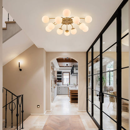 12-Light gold globe semi-flush mount ceiling light with frosted shades in bright hallway.