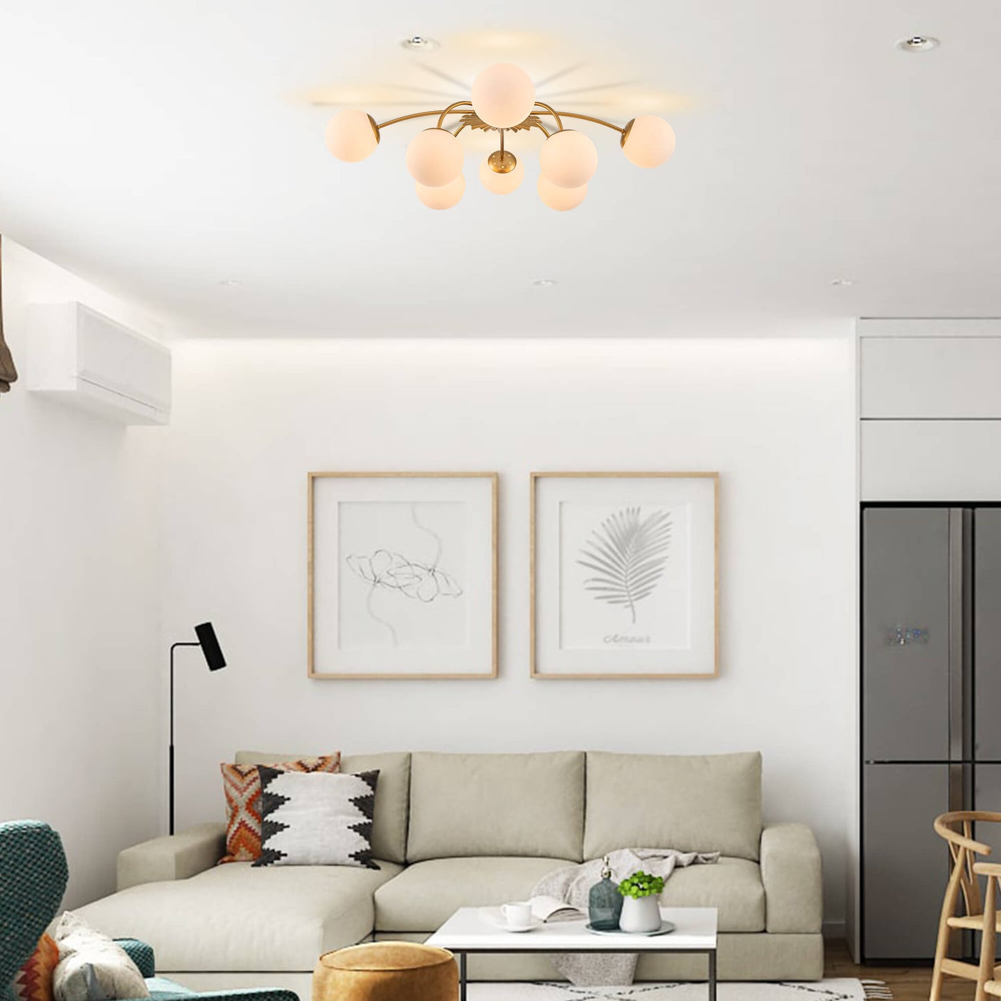 8-Light modern gold globe ceiling light installed in a living room above a cream-colored sectional sofa.