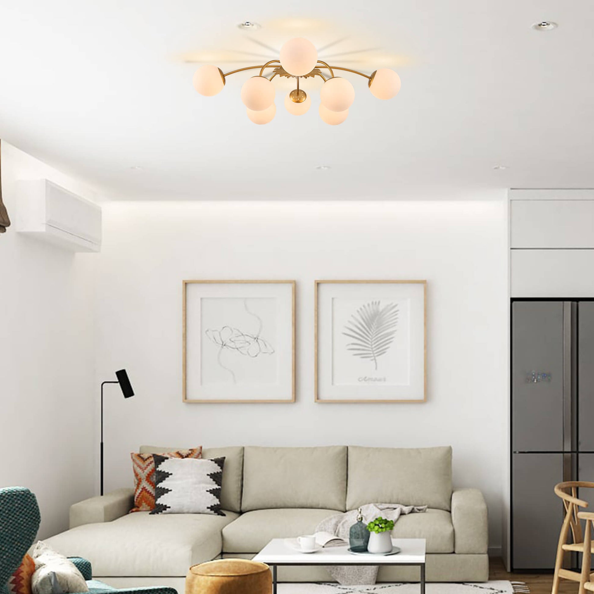 8-Light modern gold globe ceiling light installed in a living room above a cream-colored sectional sofa.