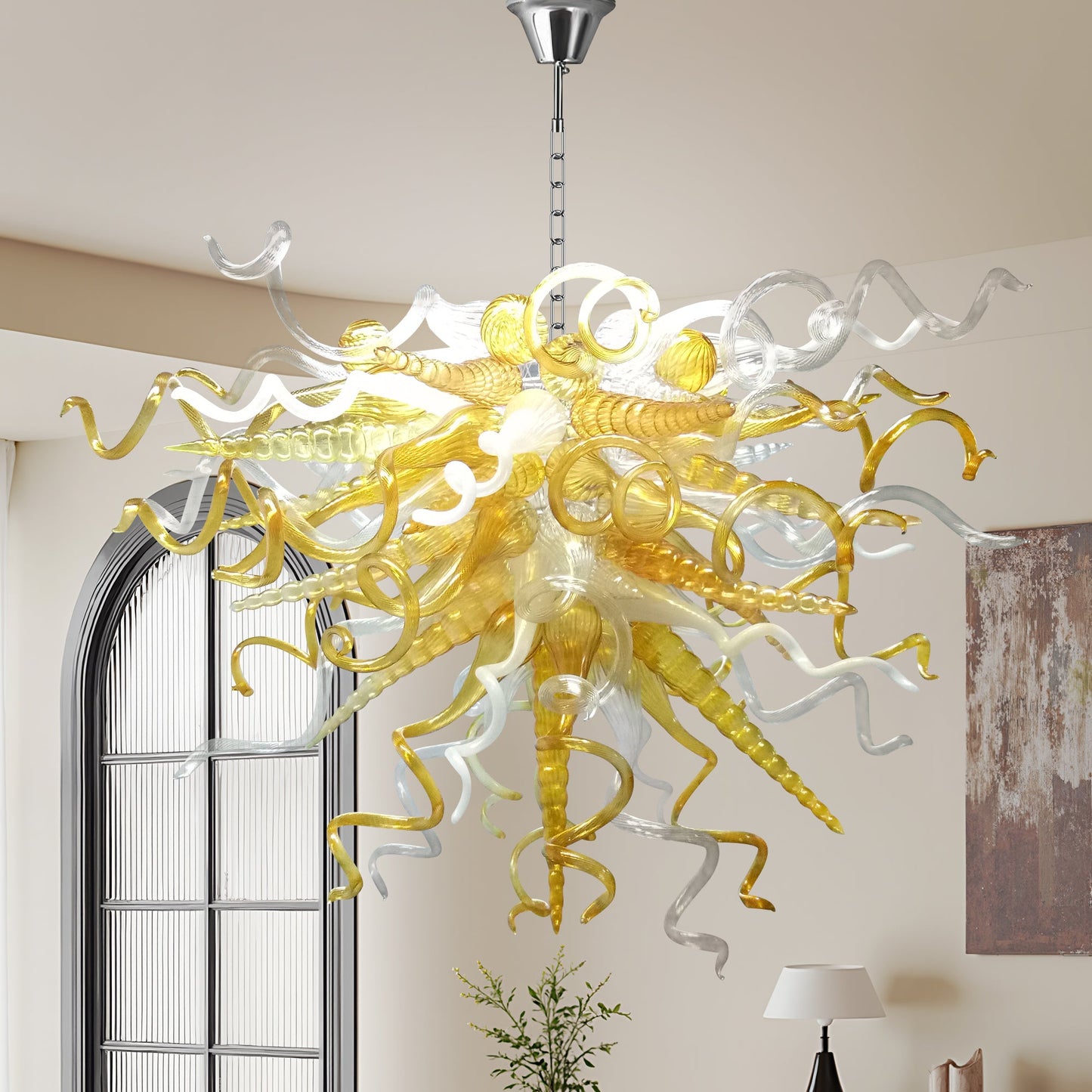 Amber and clear blown murano glass chandelier hanging a modern high-ceiling.