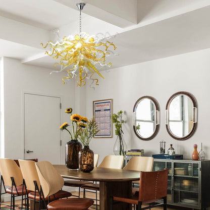 Amber and clear hand blown murano glass chandelier over a contemporary dining table.