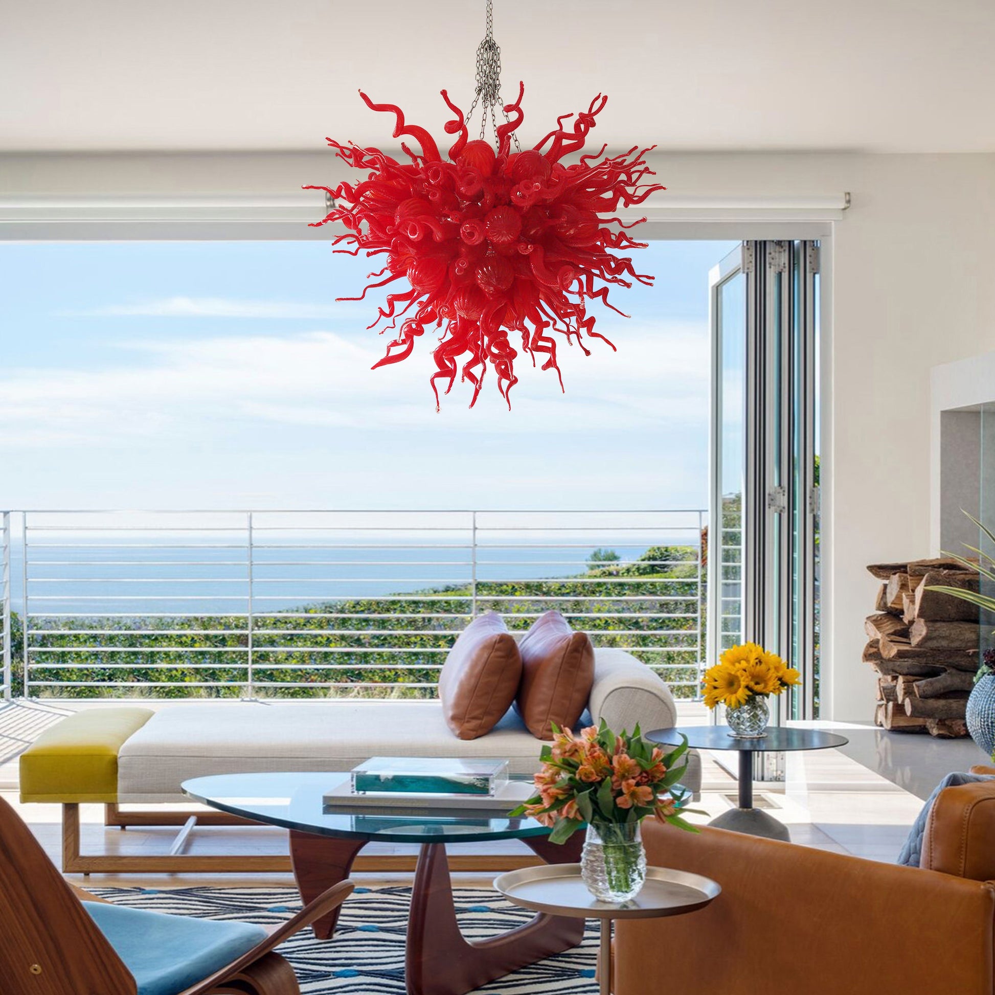 Large red hand blown art glass chandelier providing a dramatic focal point in a living area.