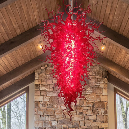 Close-up of the densely packed, intricate red murano blown glass tendrils and spirals, showcasing texture and depth.