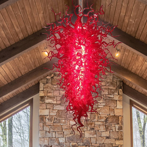 Close-up of the densely packed, intricate red murano blown glass tendrils and spirals, showcasing texture and depth.