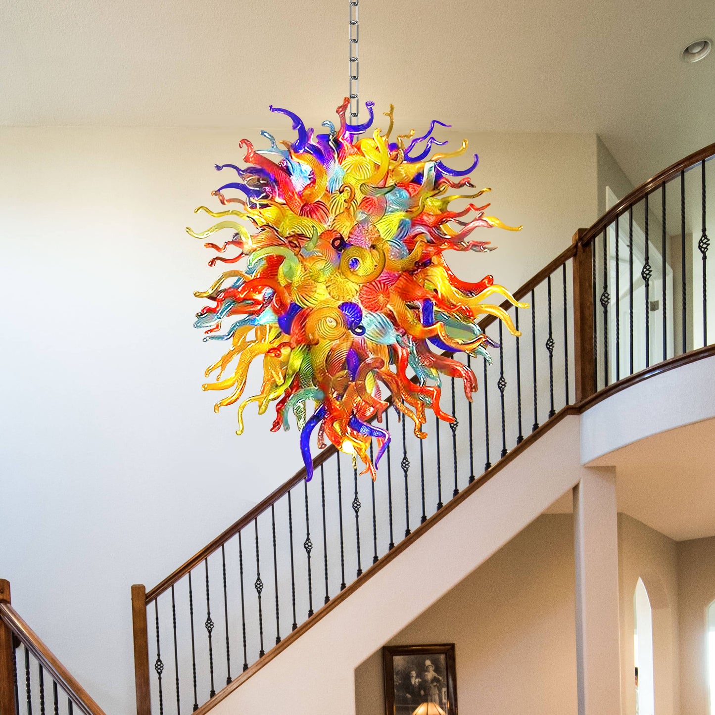 Colorful glass chandelier in Chihuly type hanging in a staircase