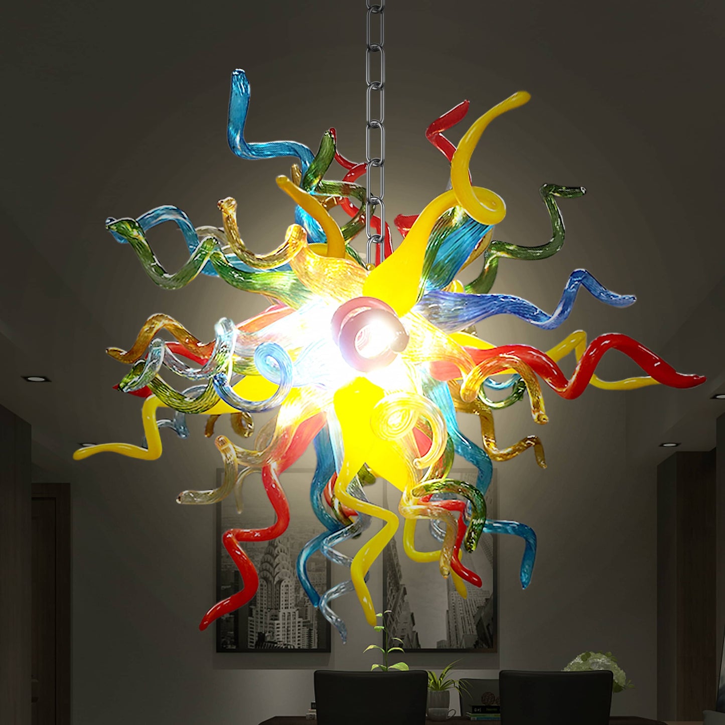 Chihuly colorful blown glass chandelier hanging in a room with light on.