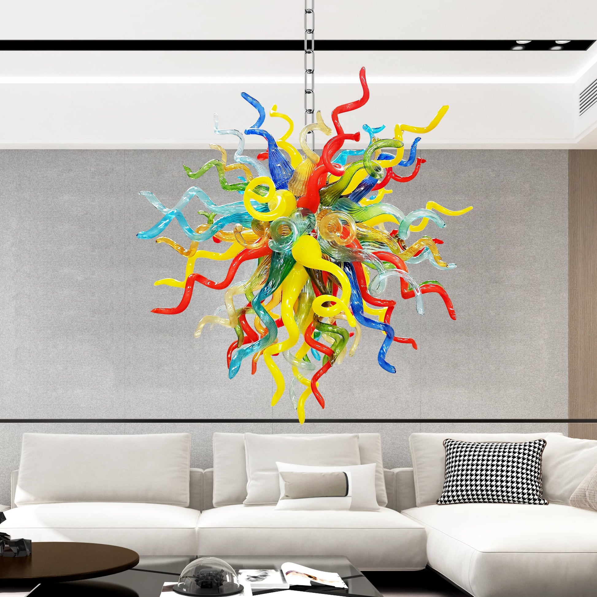 Colorful blown glass chandelier hanging above a modern living room with a white sofa.