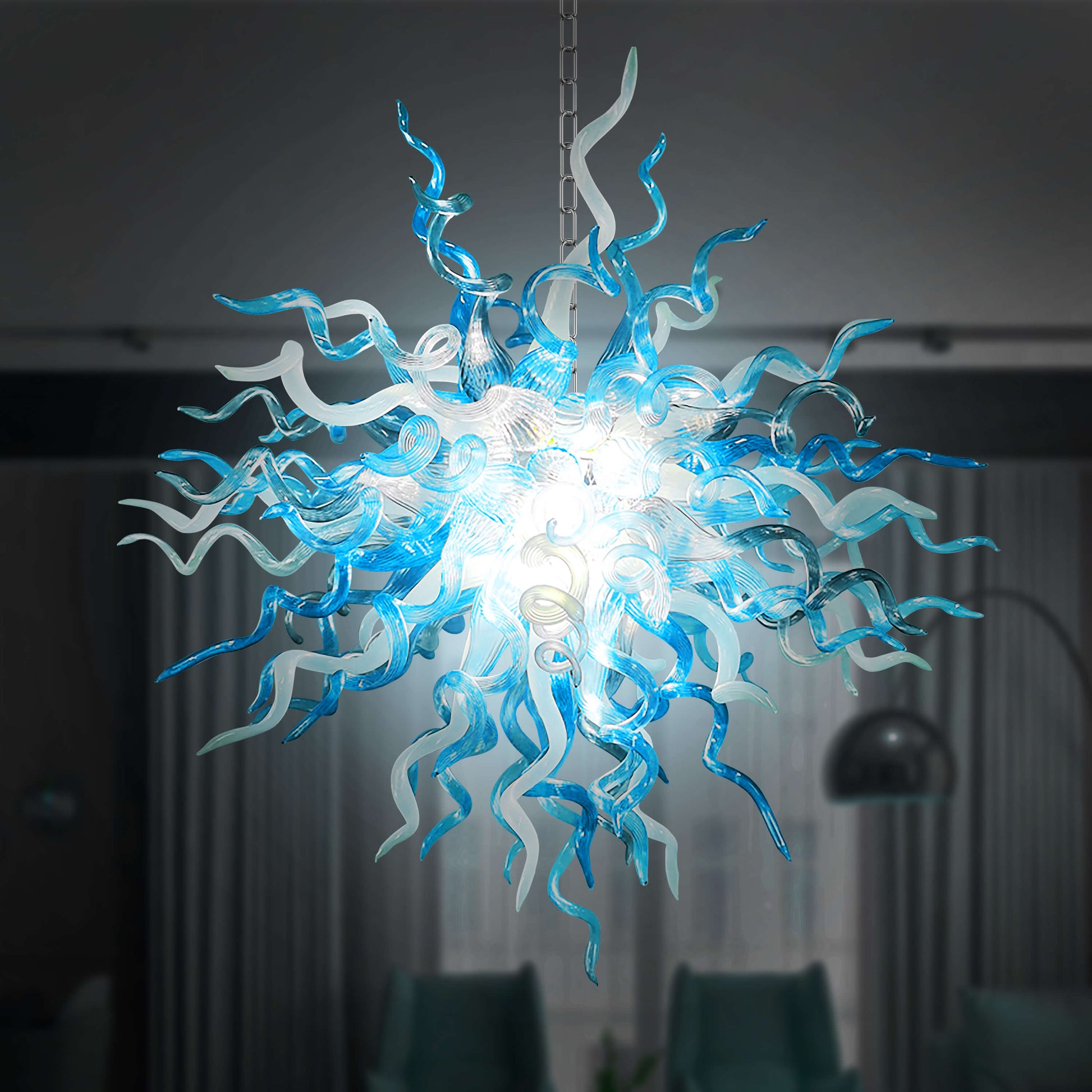 Chihuly chandelier with blue and white  blown glass design in a dark room