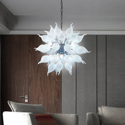 Modern sputnik blown glass chandelier hanging in a living room with gray walls and a sofa.