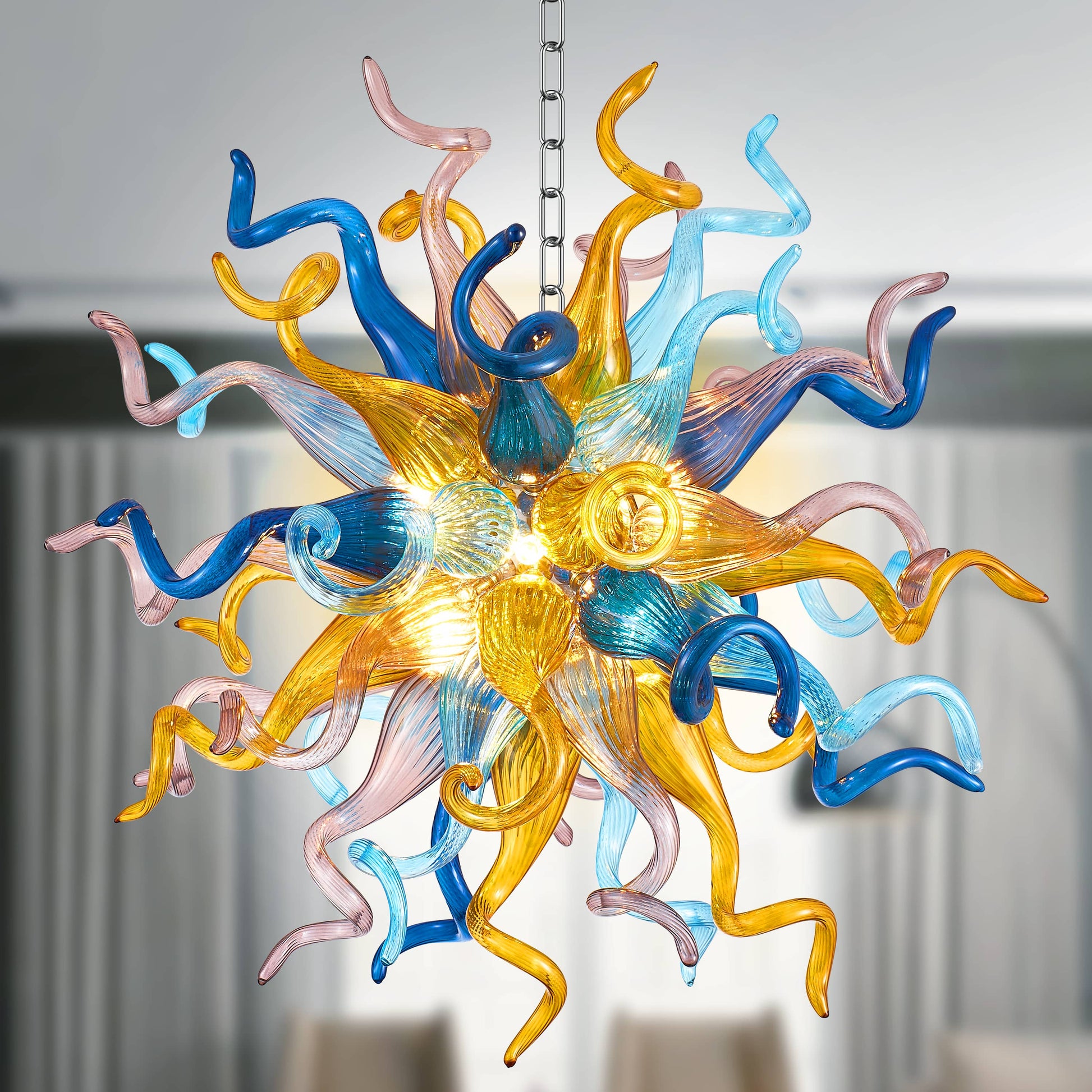 Colorful blown glass chandelier with blue, yellow, and pink hues in sputnik shape