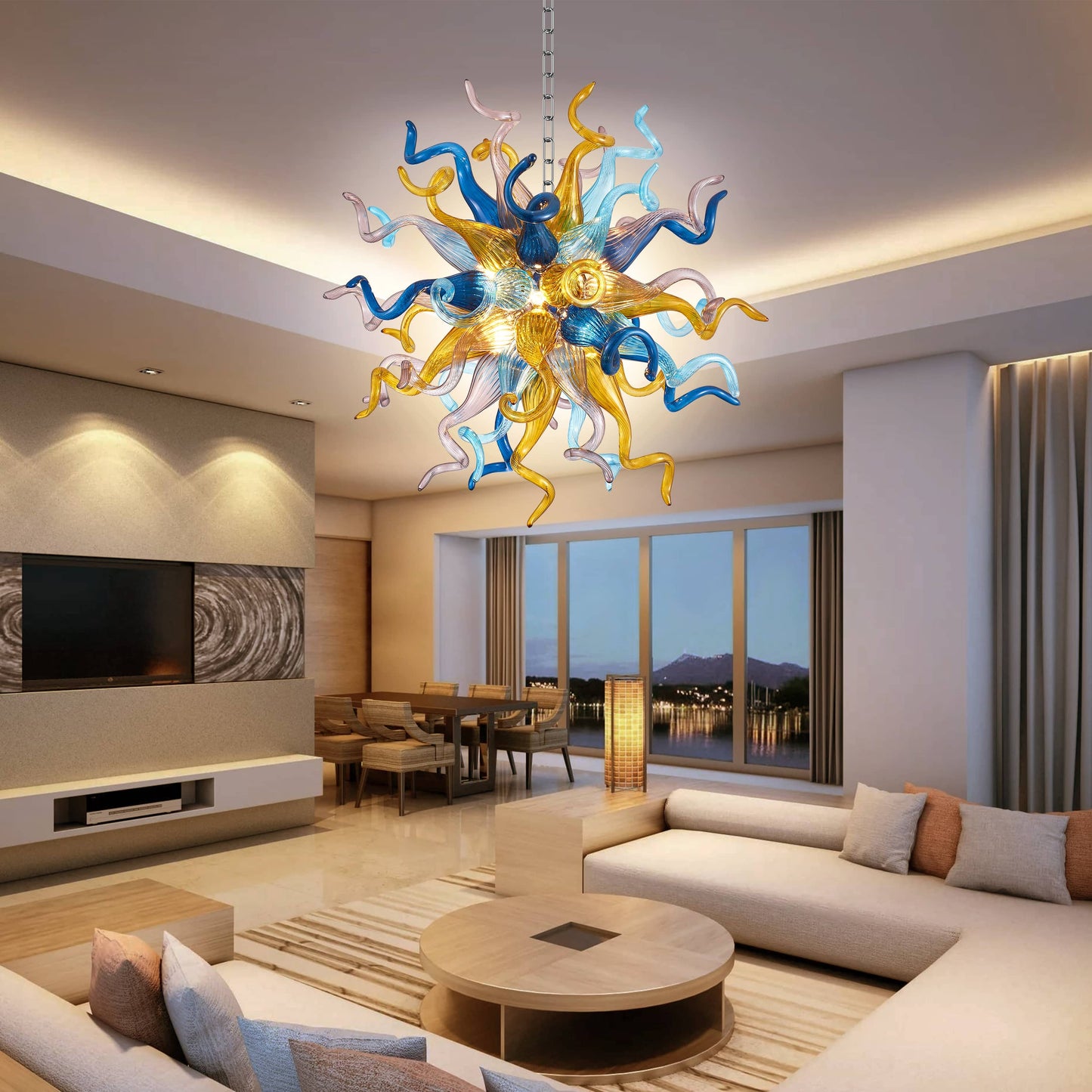 Modern living room with a colorful sputnik Chihuly chandelier, sofa, and view of a lake.