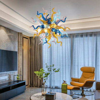Chihuly style art chandelier hanging in a modern living room with a yellow armchair and large windows.