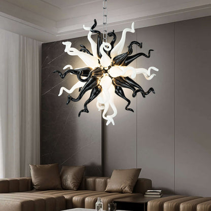 Modern Style Blown Glass Chandelier Black & White Burst hanging in a living room with a brown sofa and gray walls.