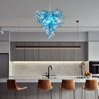 Modern kitchen with a blue and white chandelier, brown stools, and a marble countertop.