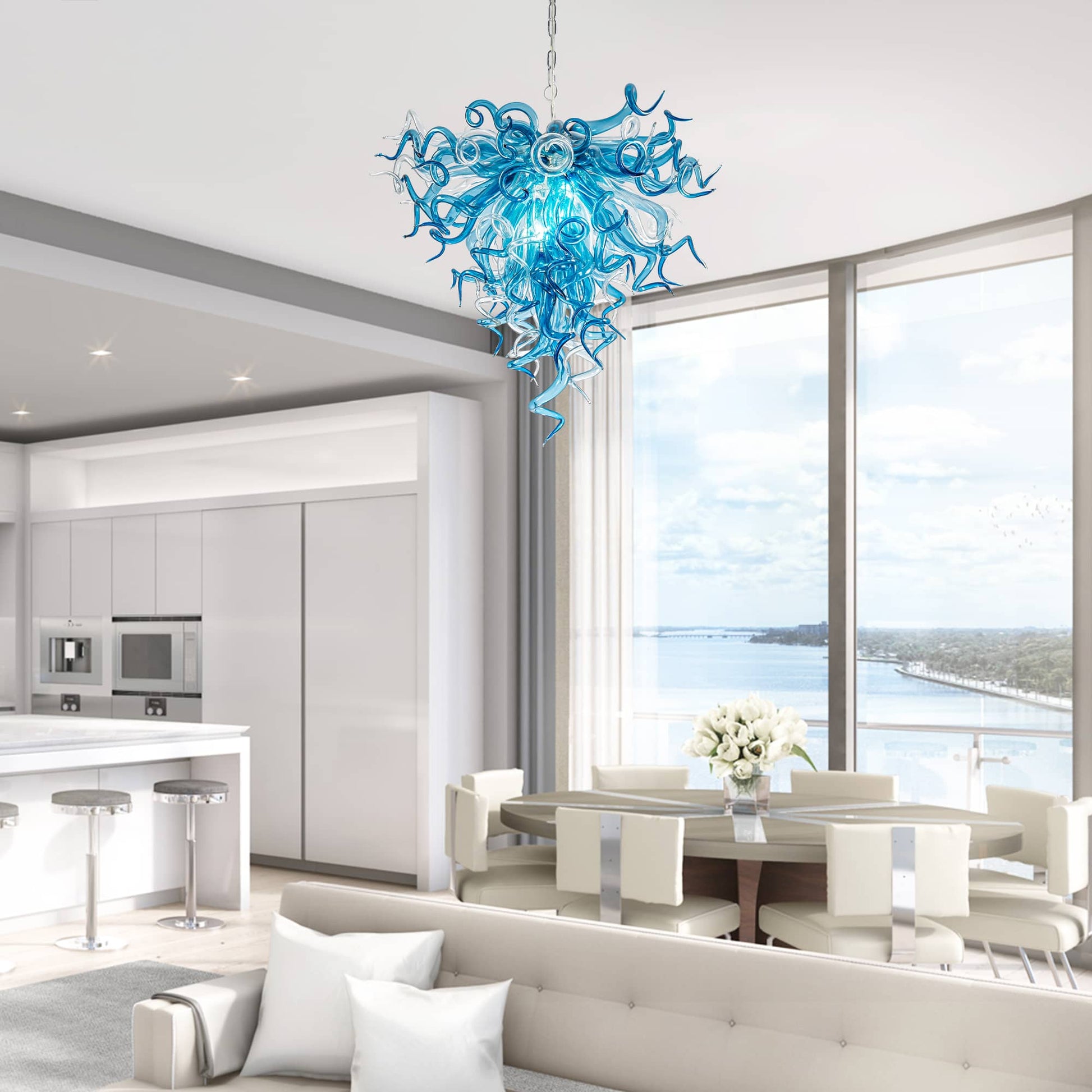 Modern interior with a blue chandelier, dining table, and kitchen.