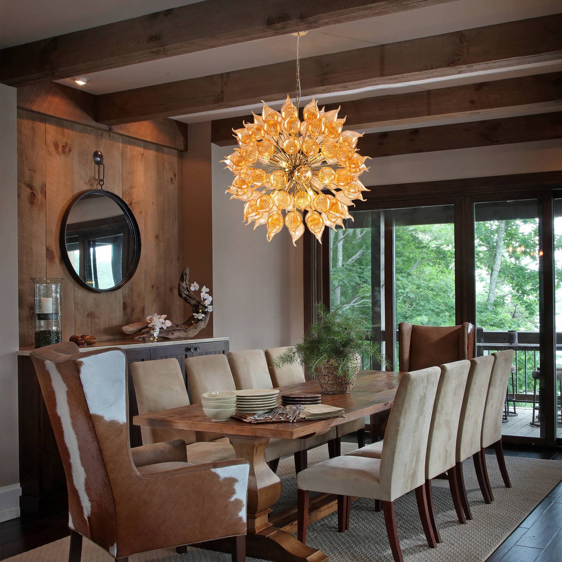 Dining room with a large yellow artic chandelier, wooden table, and chairs.