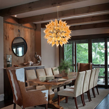 Dining room with a large yellow artic chandelier, wooden table, and chairs.
