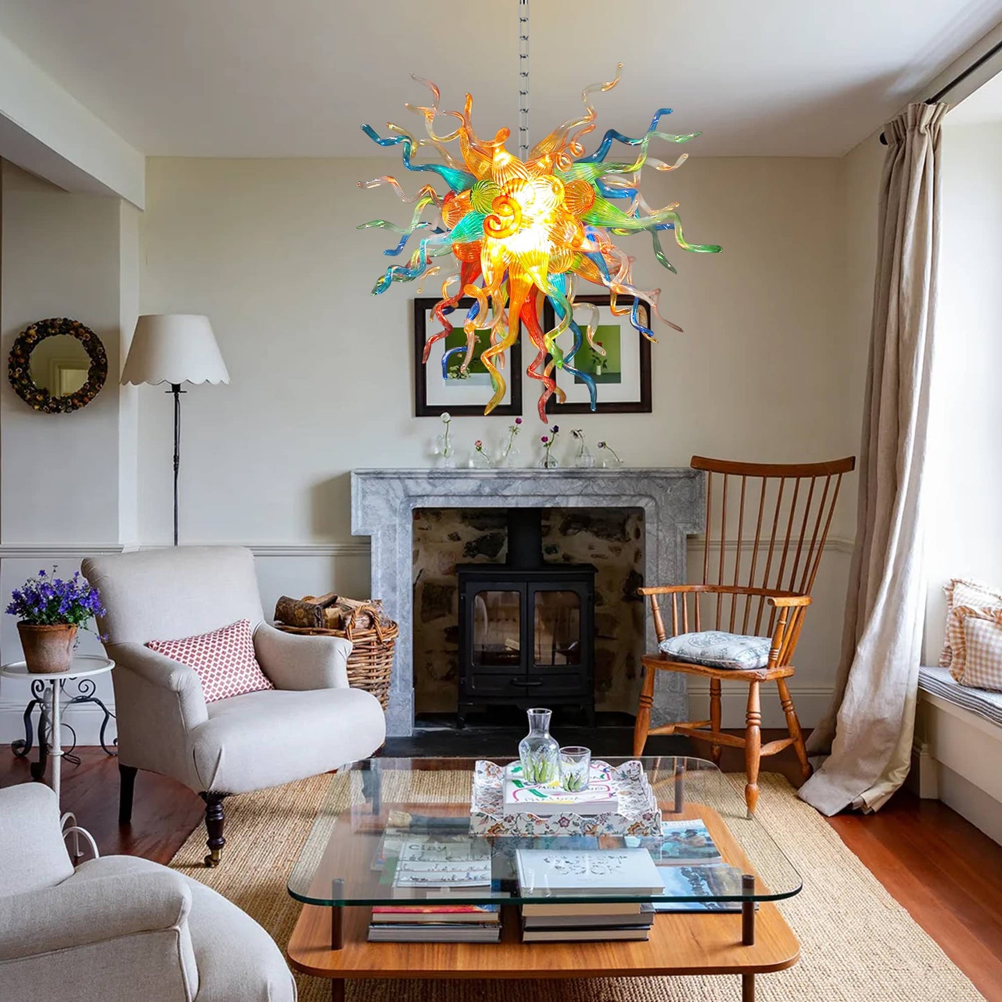 Living room with a colorful Chihuly chandelier, fireplace, and furniture.