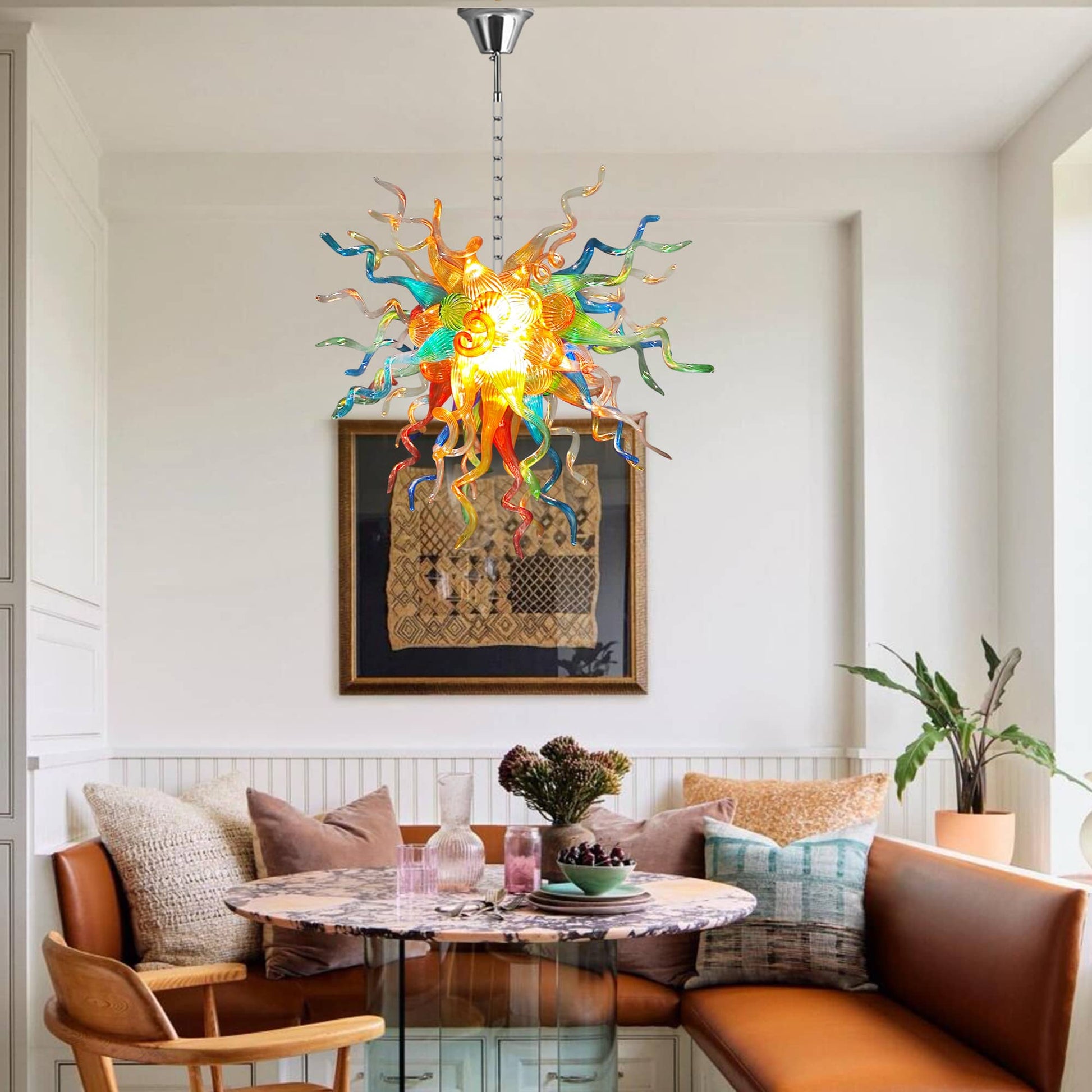 Colorful Chihuly like chandelier hanging above a dining table with chairs in a modern living room.