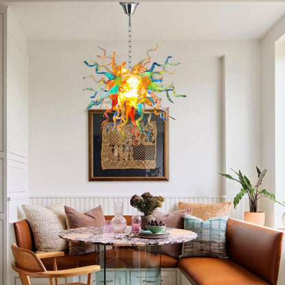 Colorful Chihuly like chandelier hanging above a dining table with chairs in a modern living room.