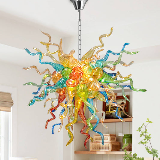 Modern Style Colorful Blown Glass Chandelier  hanging in a room with a white wall and wooden shelf
