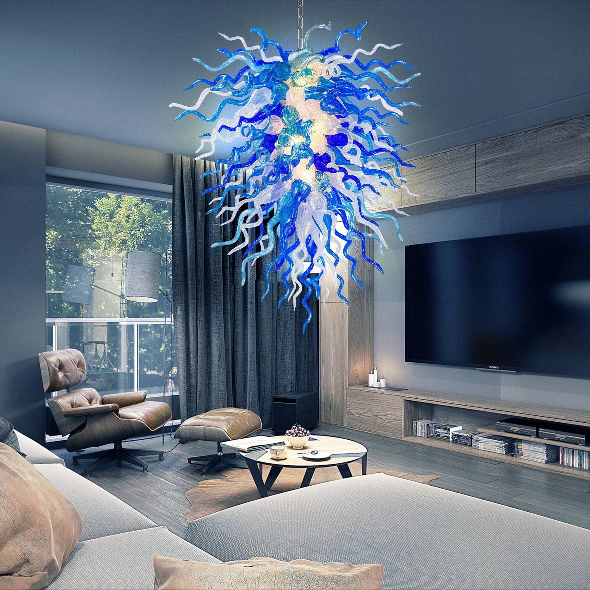 Modern living room with a large blue and white Chihuly chandelier, sofa, coffee table, and TV.