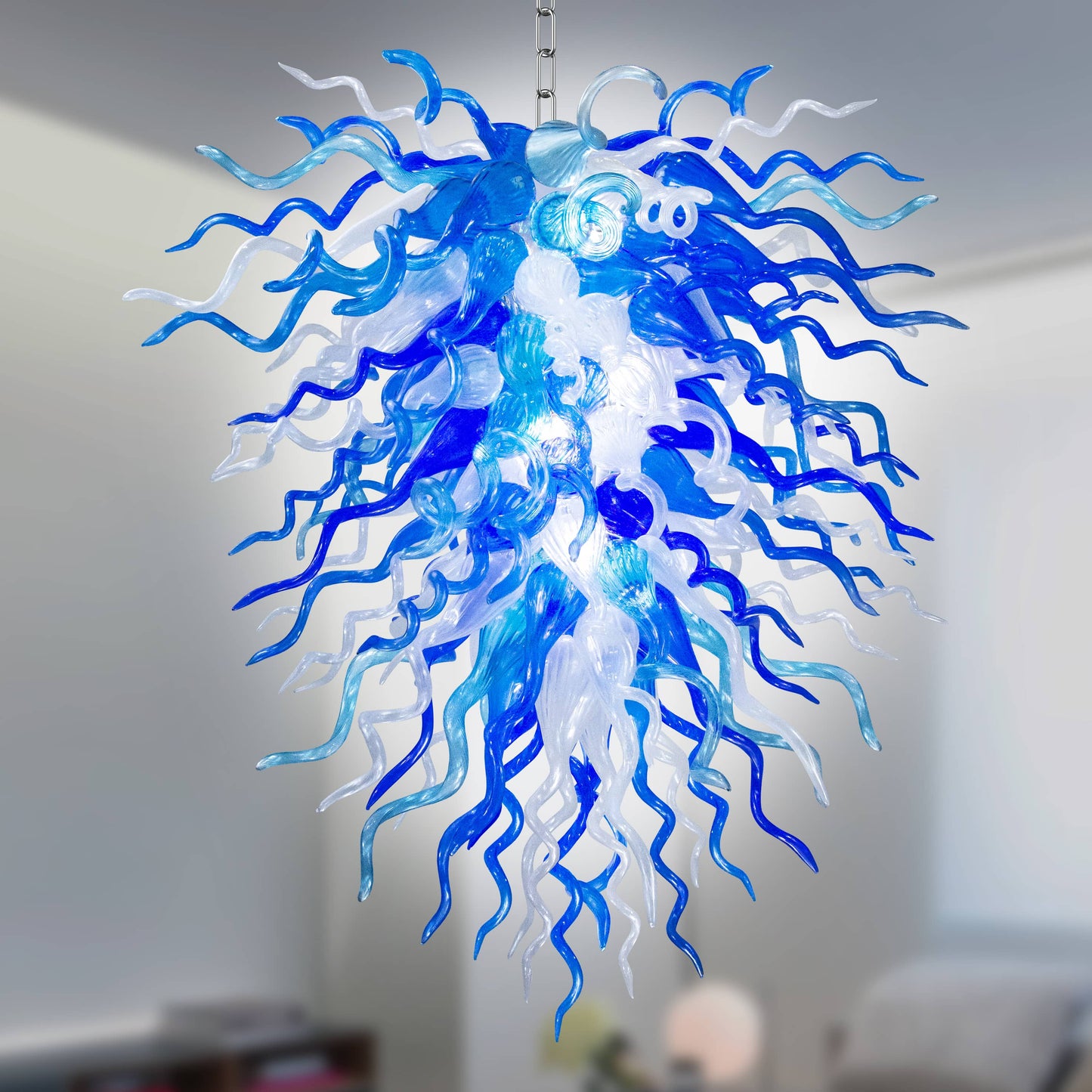 Blue and white Chihuly glass chandelier hanging in a room for both decor and lighting