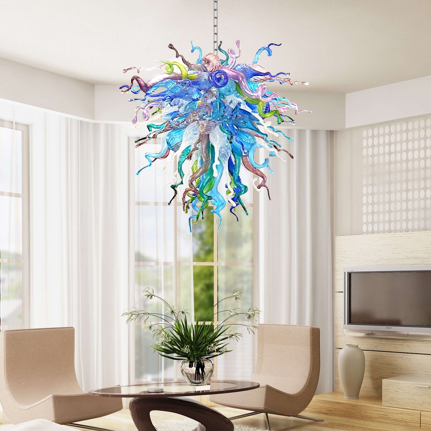 Colorful blown glass chandelier hanging in a modern living room with a table and chairs.